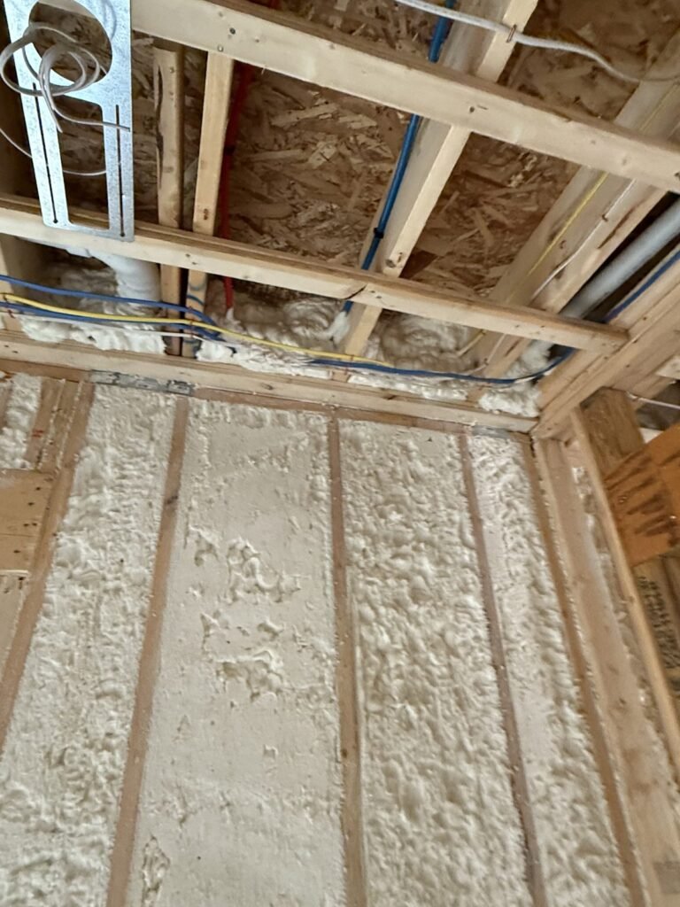 Spray foam wall and ceiling in a basement corner - spray foam insulation in Northfield, MA