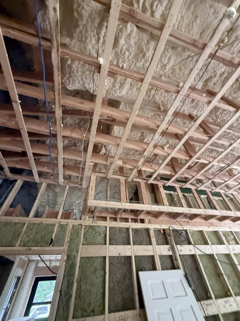 Strapped and foamed ceiling over a room with windows and a door - spray foam insulation in Nantucket, MA
