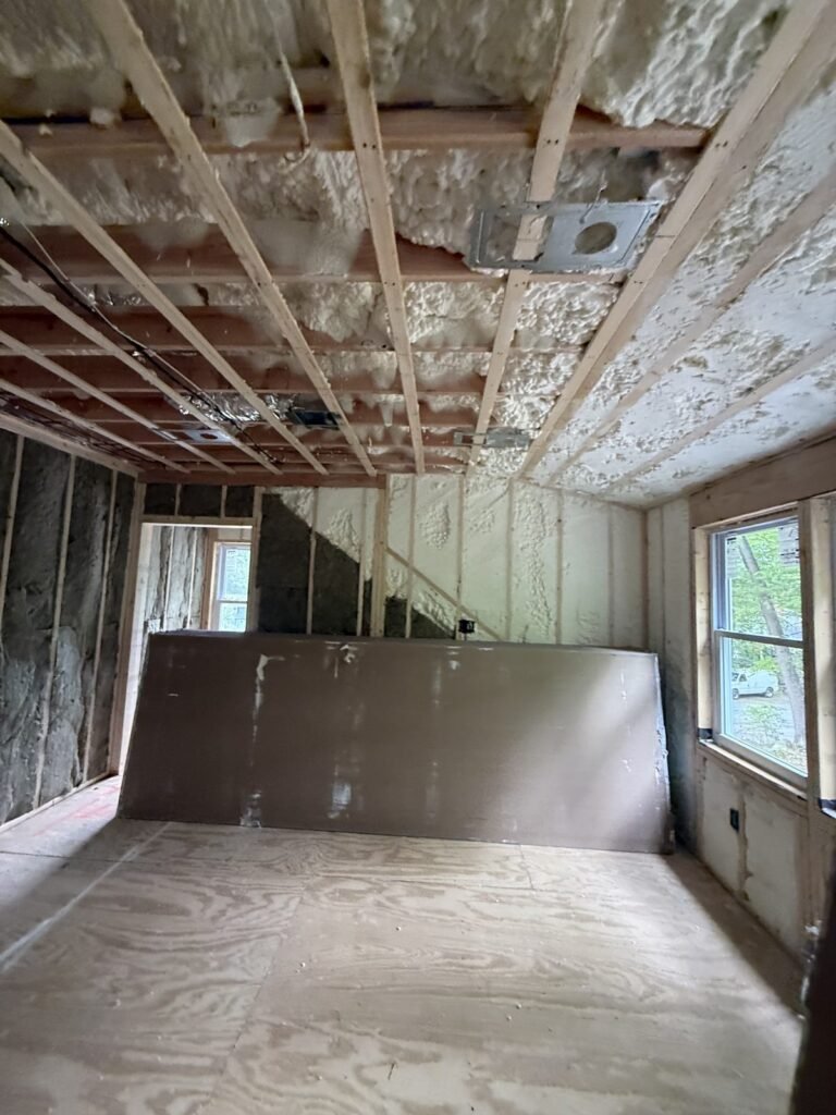 Spray foam ceiling and walls in a room with stacked drywall - spray foam insulation in Williamsburg, MA