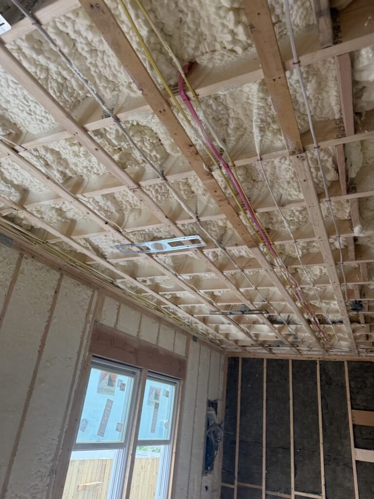 Spray foam on the ceiling above strapping and electrical wiring - HERS rating in Acushnet, MA