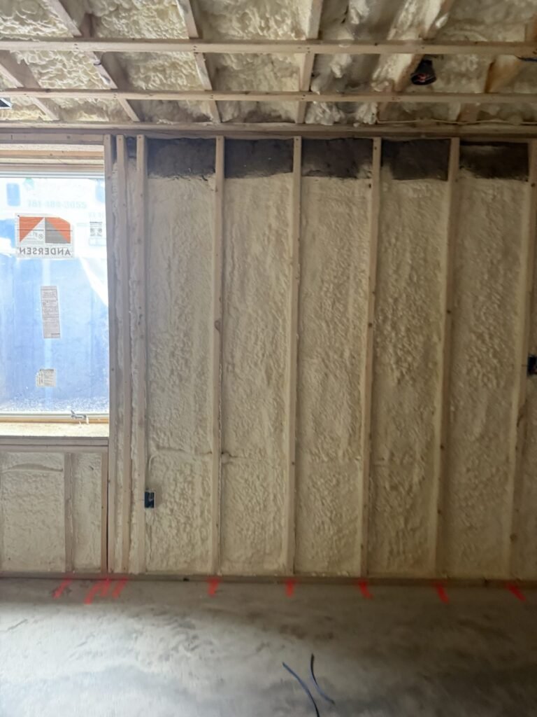 Spray foam on basement walls along a window - spray foam insulation in Wareham, MA