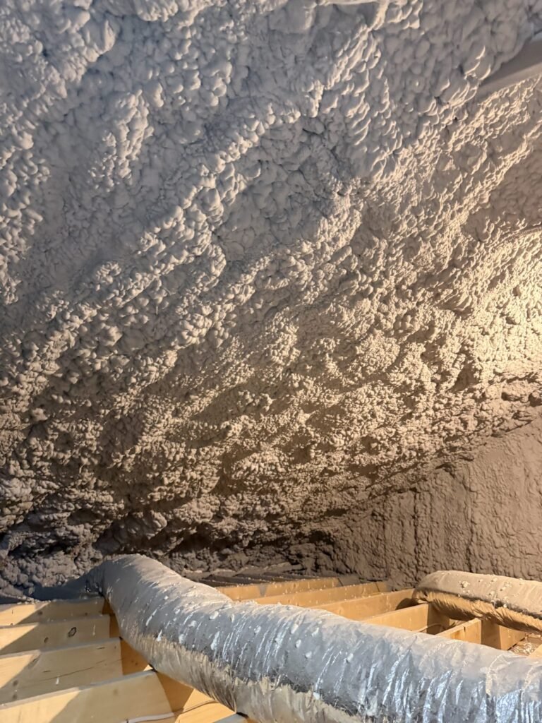 Spray-foamed attic roof underside above a flexible duct run - HERS rating in Mansfield, MA