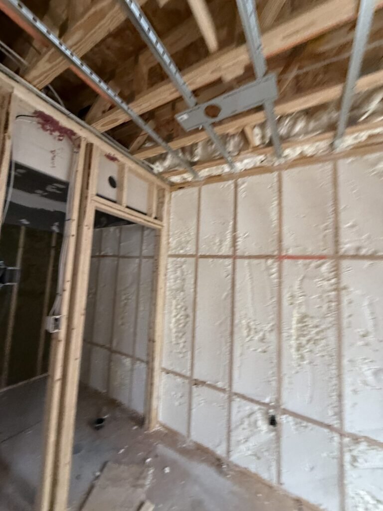 Spray-foamed wall bays around an interior door opening - HERS rating in Bellingham, MA