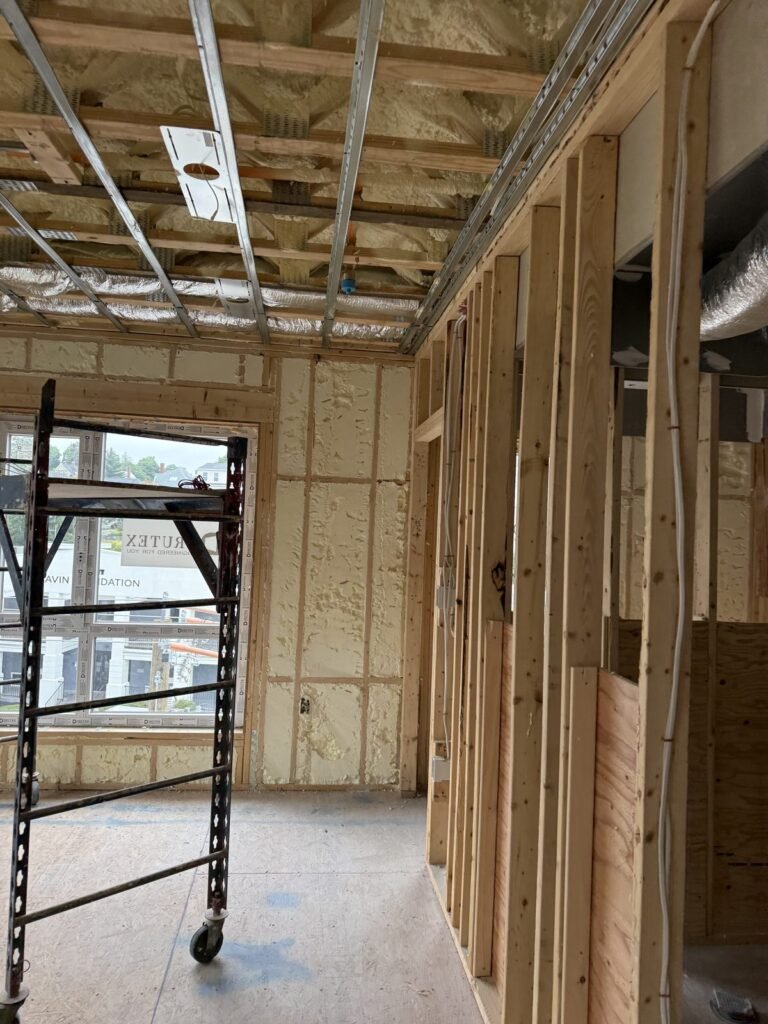 Framed interior with spray foam and scaffolding near the windows - HERS rating in Ashby, MA