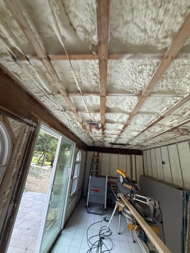 Spray foam ceiling and walls in a sunroom with sliding doors - spray foam insulation in Berlin, MA