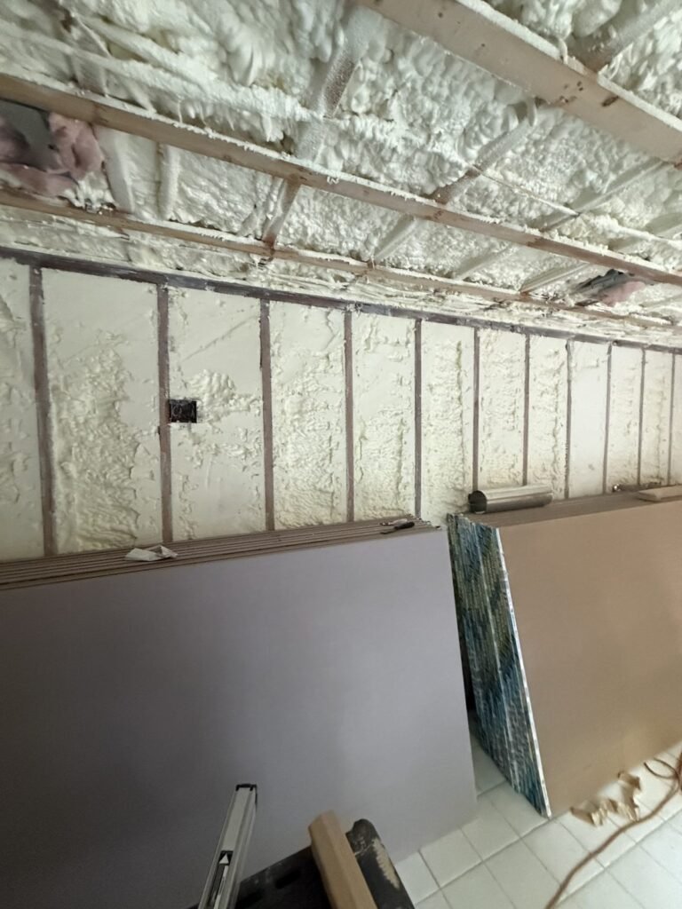 Foamed wall with drywall sheets leaning against it - HERS rating in Billerica, MA