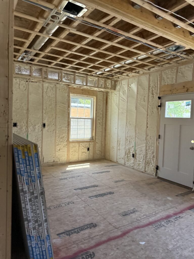 Foamed walls around a window and exterior door with ceiling strapping - HERS rating in Auburn, MA