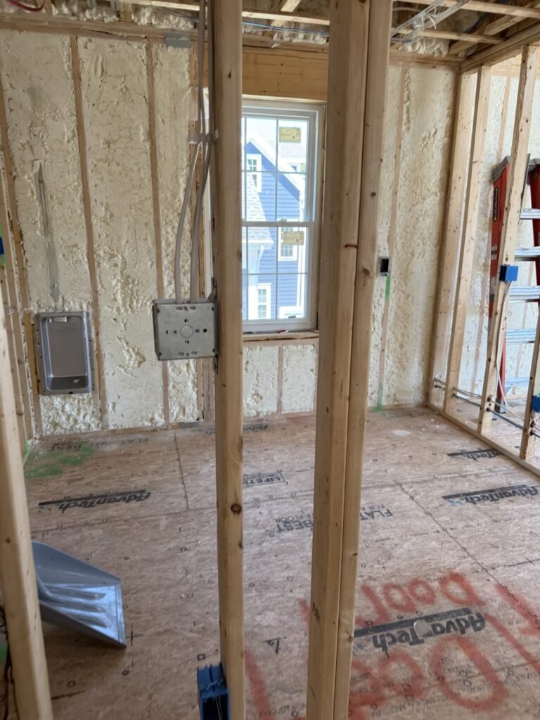 Framed room with a window, foamed walls and electrical boxes on the studs - spray foam insulation in Millis, MA