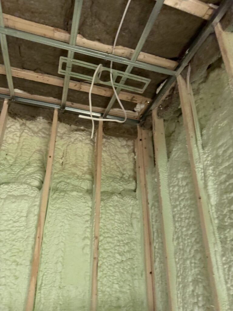 Closed-cell spray foam on exterior walls under a steel ceiling grid - HERS rating in Westfield, MA