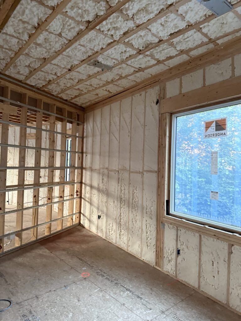 Room corner with foamed walls and ceiling around a large window - HERS rating in Egremont, MA