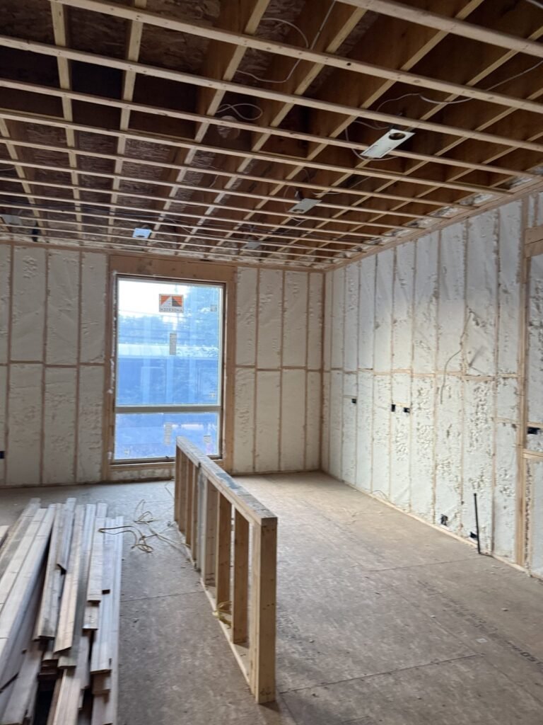 Spray-foamed room with exposed ceiling strapping and a window opening - HERS rating in Harvard, MA