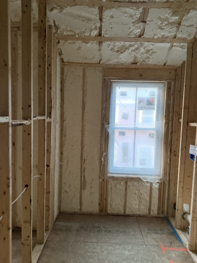 Framed interior wall in front of a foamed exterior wall and window - HERS rating in Foxborough, MA