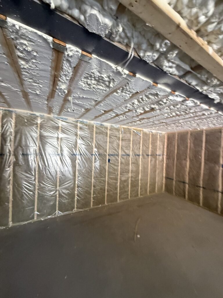 Large room with spray-foamed walls and ceiling meeting at the top plates - HERS rating in New Braintree, MA