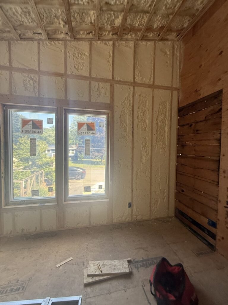 Room with two windows and spray-foamed walls and ceiling - spray foam insulation in Eastham, MA