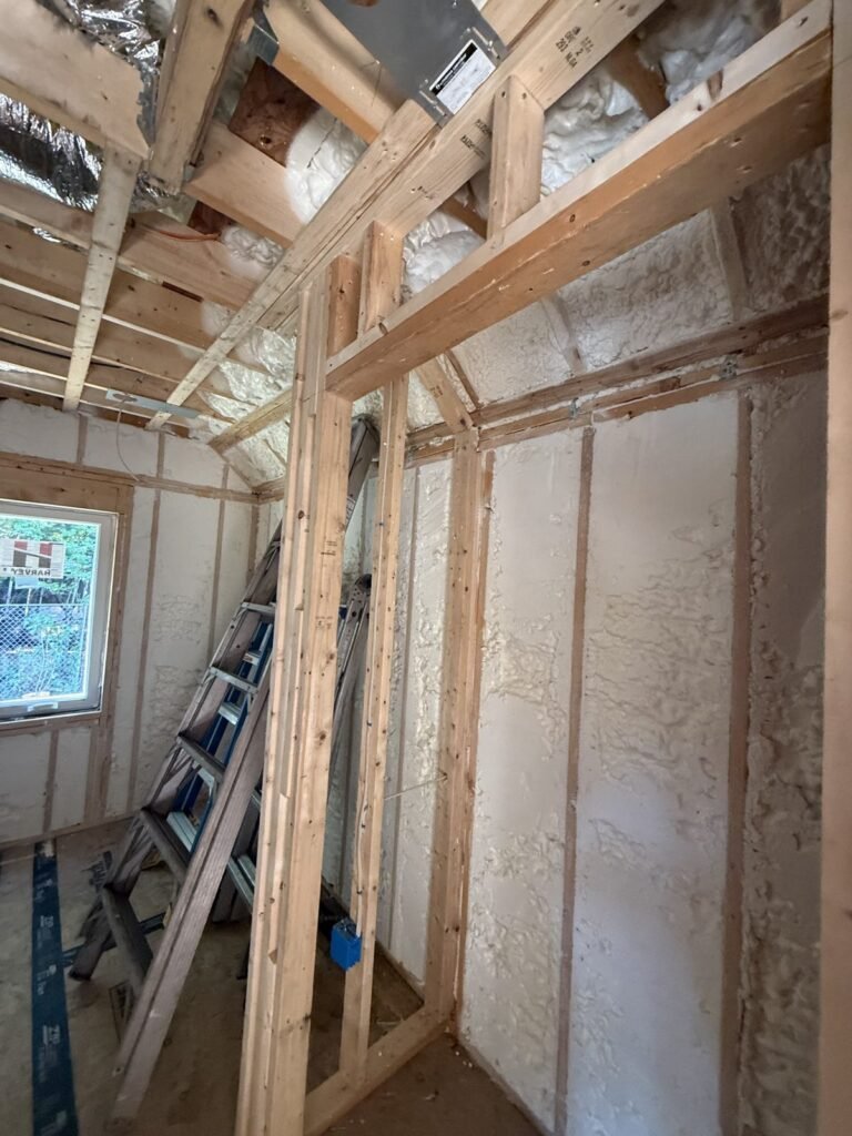 Foamed walls with a stepladder and small window in a framed room - HERS rating in Brewster, MA