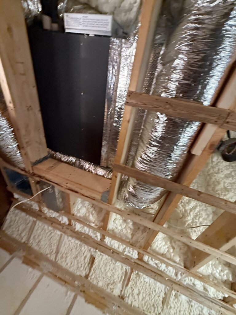 Ducted air handler and foil-wrapped ducts between ceiling joists - HERS rating in Duxbury, MA