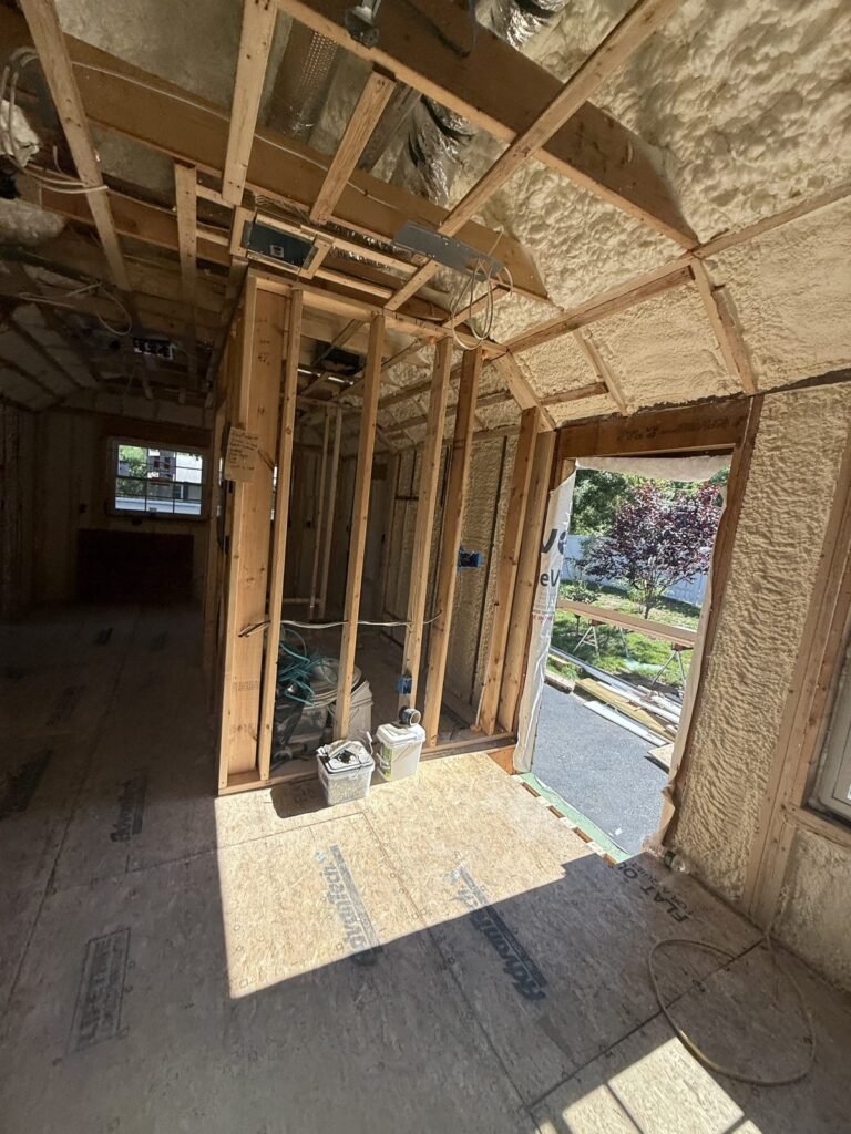 Open-cell spray foam in framed walls beside an open doorway - HERS rating in Bridgewater, MA