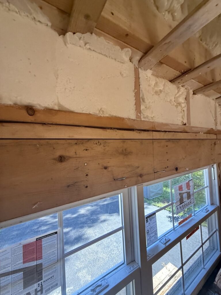 Spray foam above the header of a band of windows - spray foam insulation in Townsend, MA