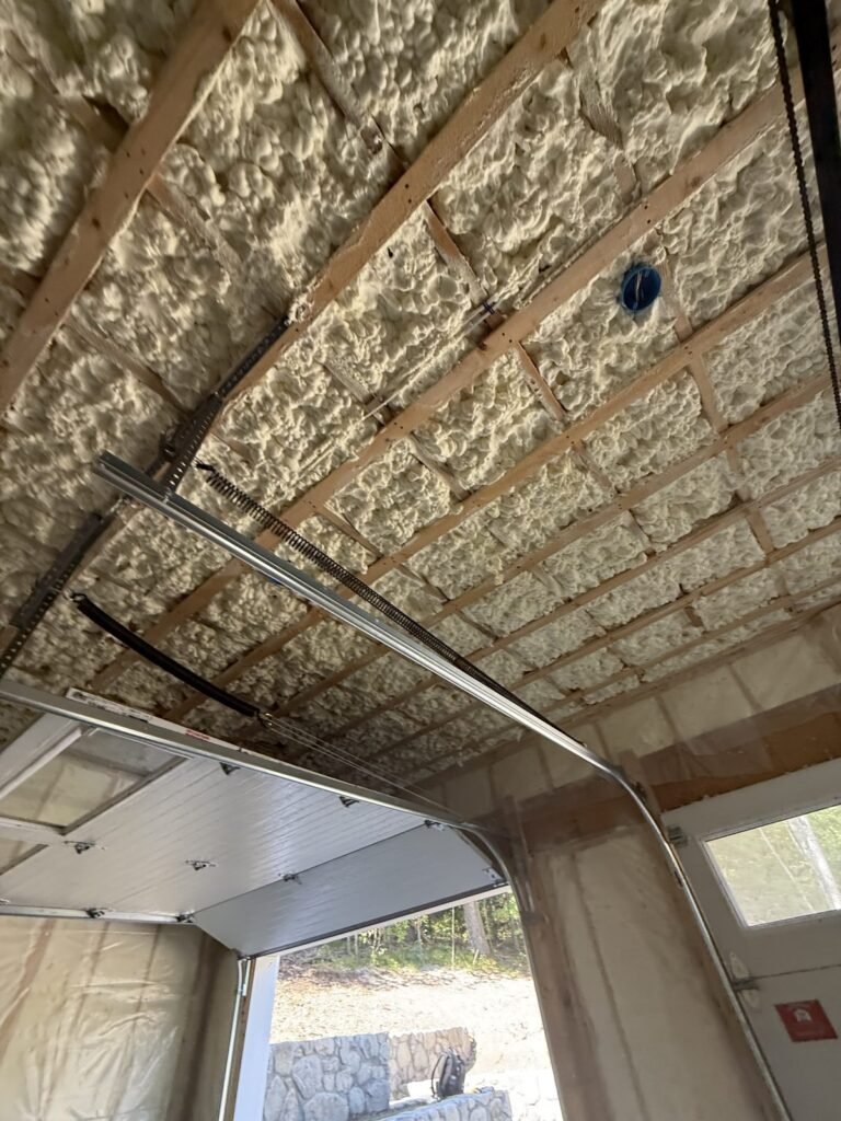 Spray foam on a garage ceiling and walls around the overhead door - spray foam insulation in Plainfield, MA