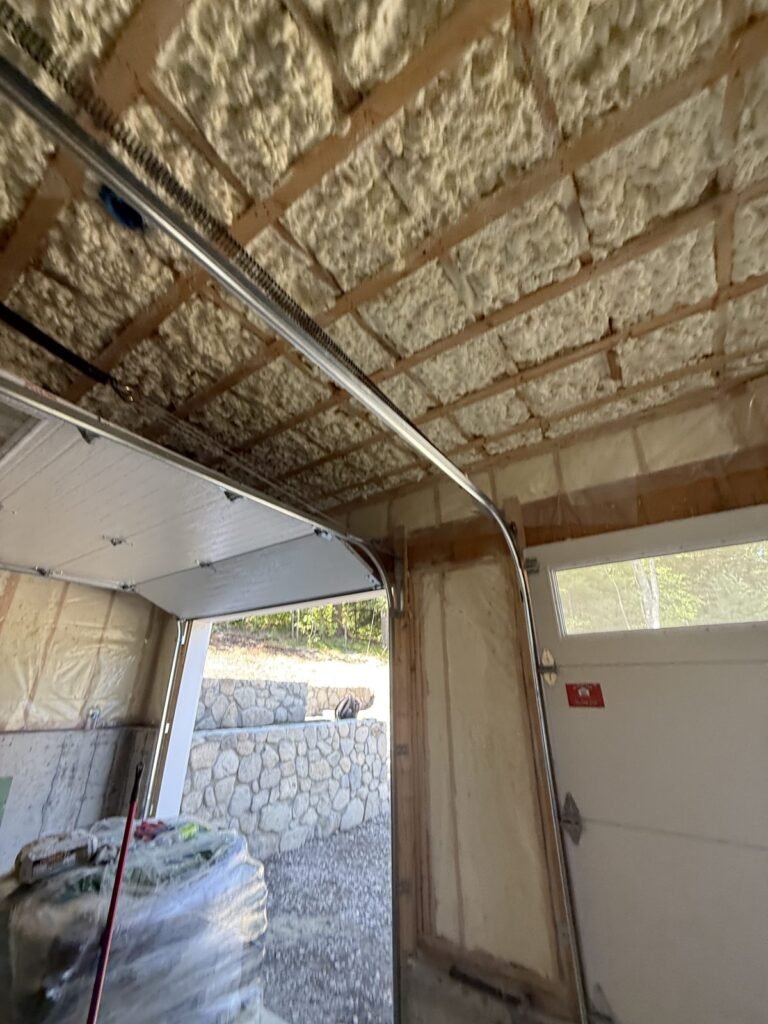 Spray-foamed garage ceiling with the overhead door open to the driveway - HERS rating in Duxbury, MA