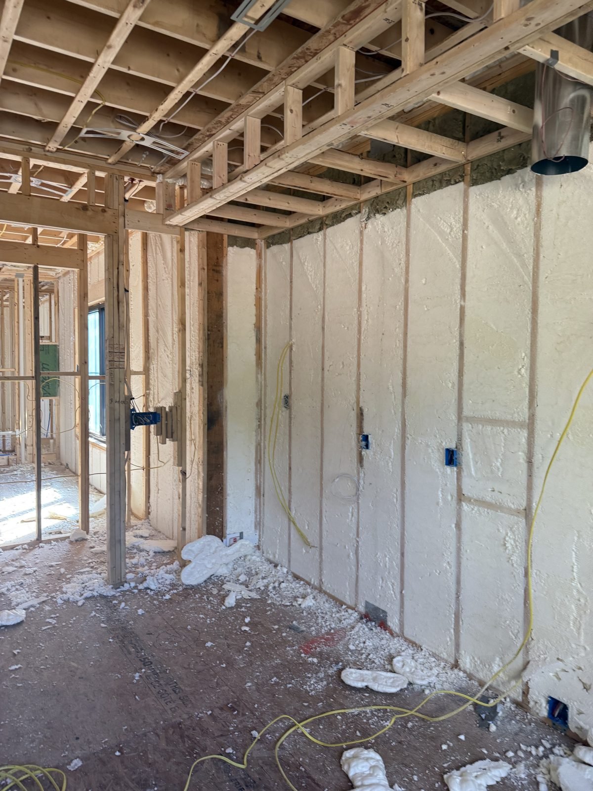 Spray foam insulation and air sealing in the exterior walls of a Massachusetts home before drywall
