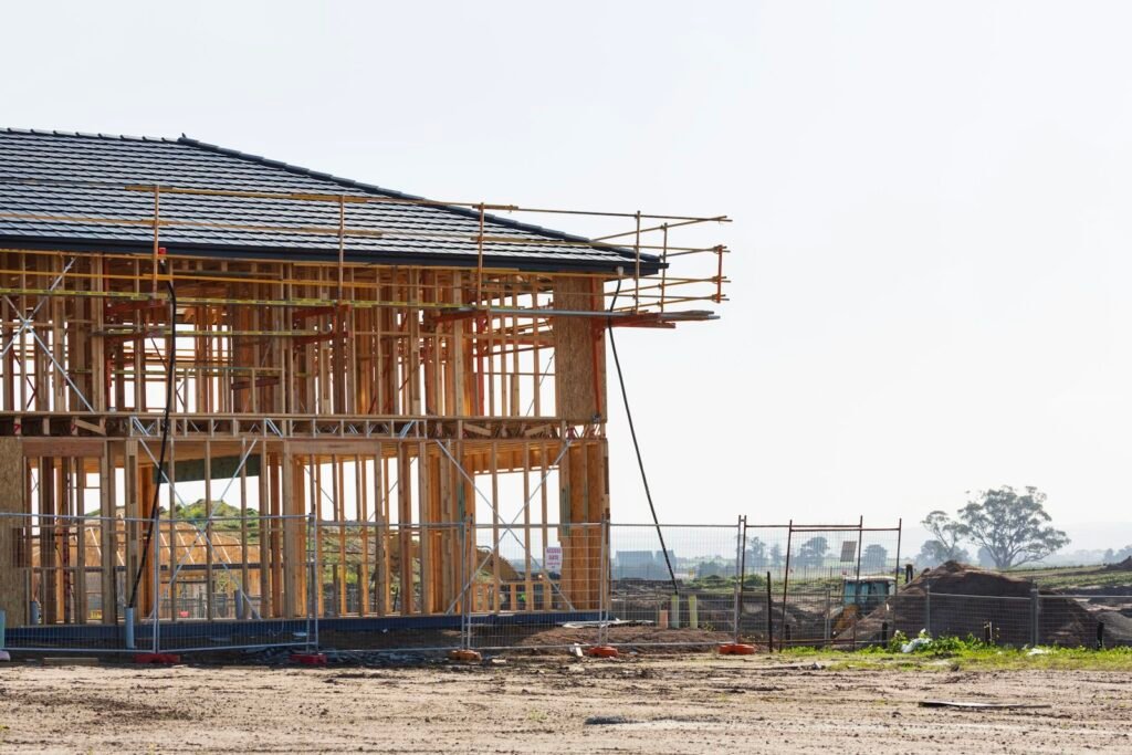 Two-story home in wood framing with scaffolding along the roof edge - HERS rating in Worthington, MA